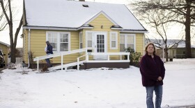 Jen Coghlan outside the home where she grew up in Perry, Iowa. Her father, Henry Ruhl, plans to leave the house to her, but Coghlan expects she'll have to sell it after he dies to settle a $226,611 from Medicaid for the care of her mother, who died in 2022. Coghlan says the family didn't realize that her mother was on Medicaid.