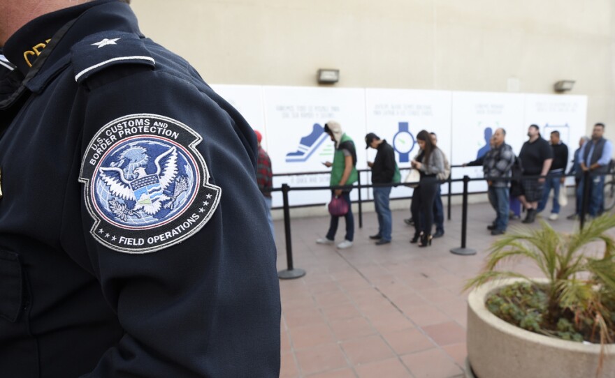 Pedestrians crossing from Mexico into the United States at the Otay Mesa Port of Entry wait in line in San Diego, Dec. 10, 2015.