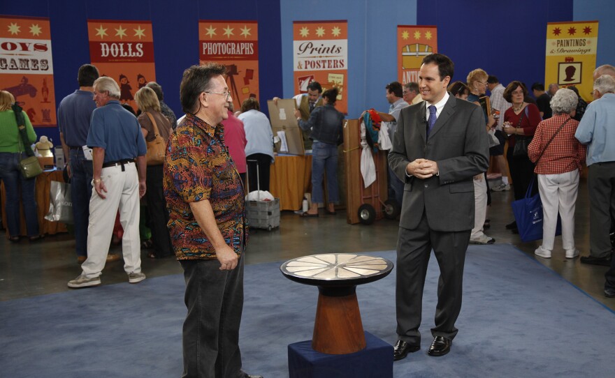 Peter Loughrey (right) appraises a Frank Rohloff table, ca. 1968, in San Jose, Calif. ANTIQUES ROADSHOW “Vintage San Jose, Hour 1” airs Monday, September 15 at 8/7C PM on PBS.