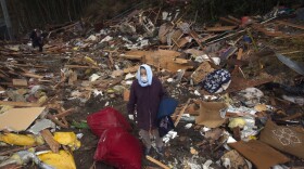 Kiyoko Kin searches through the rubble of part of her house that was washed away from the tsunami March 26, 2011 in Rikuzentakata, Japan. 