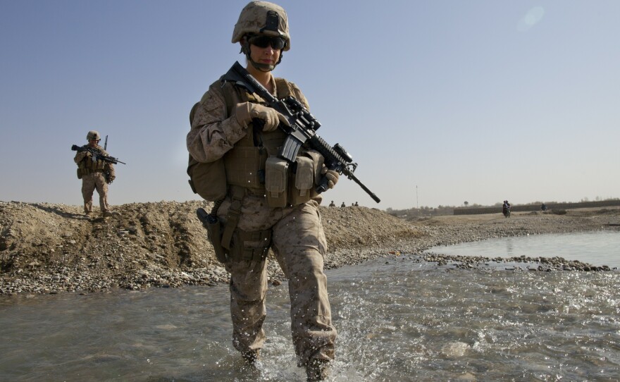 U.S. troops in Afghanistan appear to have mixed feelings about the decision lifting the ban on women in combat positions. Some women already operate in combat zones. Hospital Corpsman Shannon Crowley is shown here with her Marine Corps team in Musa Qala, Afghanistan, in November 2010.