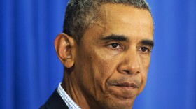 President Barack Obama pauses while addressing the media in Edgartown, Mass., Aug. 14, 2014. 