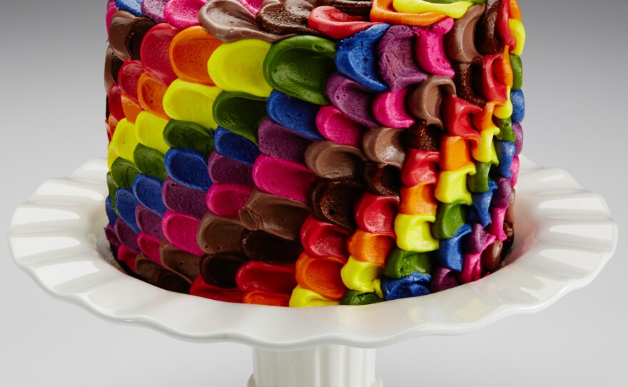 This multi-colored cake's icing is made from red cabbage juice, turmeric, annatto, beet juice, and caramel color.