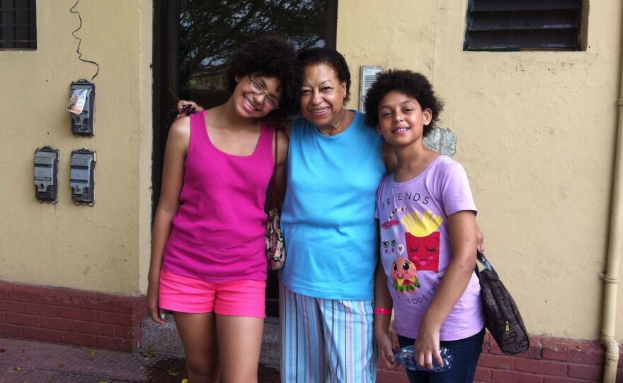 Nola, Ramona and Margo stand in front of the building where Ramona was born, during a family trip to the Dominican Republic.