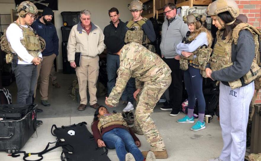 Using a student as a simulated casualty, an Army medic at Fort Bragg explains his work to a Duke University class in this undated photo.