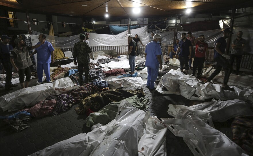Bodies of Palestinians killed by an explosion at the Ahli Arab hospital are gathered in the front yard of Al Shifa hospital, in Gaza City, central Gaza Strip, on Oct. 17. Palestinians say the devastating war between Israel and Hamas is robbing them not only of their loved ones but also of the funeral rites that long have offered mourners some dignity and closure in the midst of grief.