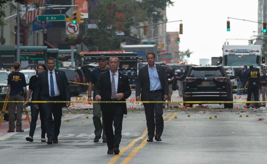 New York Governor Andrew Cuomo (R) visits the scene of an explosion on West 23rd Street Sept. 18, 2016 in New York. An explosion rocked one of the most fashionable neighborhoods of New York, injuring 29 people, one seriously, a week after America's financial capital marked the 15th anniversary of the 9/11 attacks.