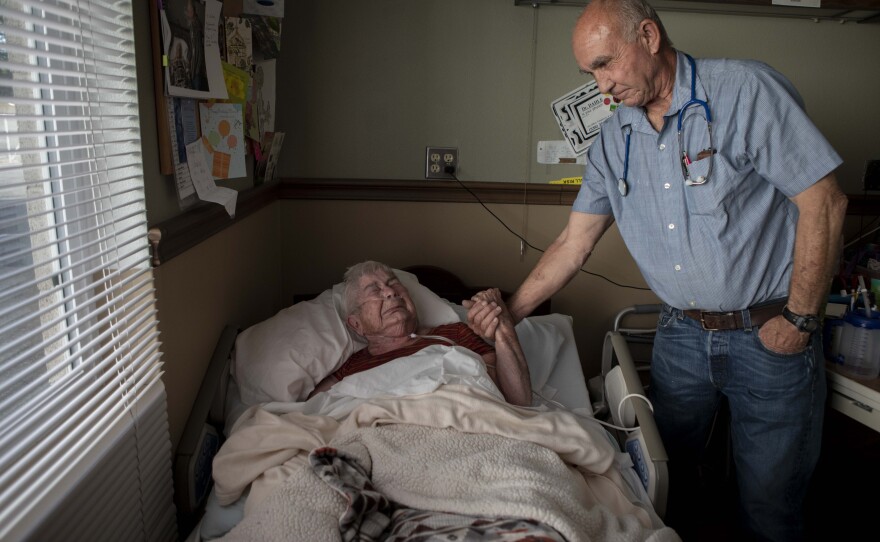 Dr. Dan Dahle visits his patient Wilma Chesbro, a former operating room nurse that he worked with for decades, in this undated photo.