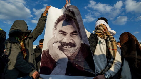 FILE - Youngsters hold a photograph of Abdullah Ocalan, the jailed leader of the militant Kurdish group, or PKK, in Diyarbakir, Turkey, Feb. 27, 2025.