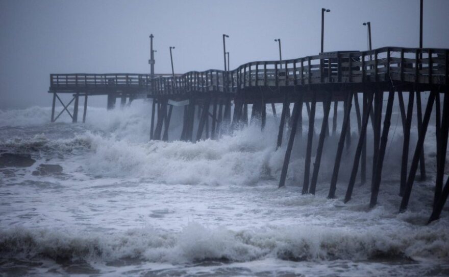 Waves crash into Avalon Pier as Hurricane Irene strikes the Outer Banks in Kill Devil Hills, N.C. earlier today.
