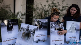 Savannah Sampson, right, and Nicole Lewis, help set up a vigil for the victims of Tuesday's fatal SUV-Metro bus collision and the subsequent crash of a TV news helicopter that was covering it in the Chatsworth neighborhood of Los Angeles, Thursday, Sept. 17, 2026.
