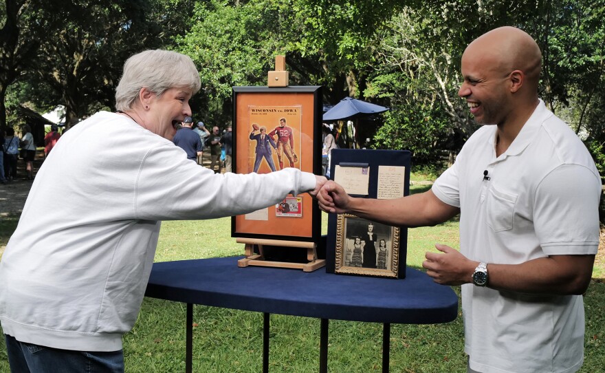 Jasmani Fracis (right) appraises a Nile Kinnick group, in Baton Rouge, LA. ANTIQUES ROADSHOW “LSU Rural Life Museum, Hour 3” airs Monday, March 25 at 8/7C PM on PBS. 