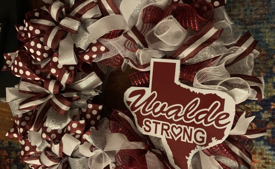 A constant line of visitors have brought injured Uvalde teacher Arnie Reyes and his family regular deliveries of meals and gifts. On a recent night, friends gave him a maroon and silver wreath in the colors for Robb Elementary School.