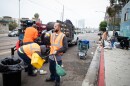 City and contract workers impound belongings during an enforcement on Commercial Street in San Diego, June 9, 2022.