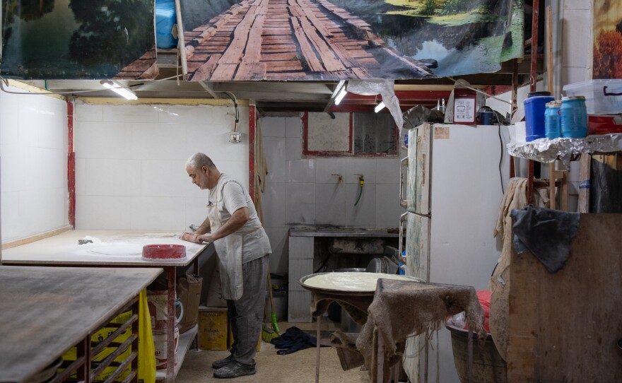 Rafe' Rummaneh prepares desserts at his bakery the Al-Am'ari refugee camp in Ramallah on April 9.