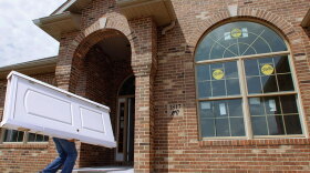 Construction worker Brian Stocks delivers doors July 15 to a  new  home under construction in Springfield, Ill. Homebuilder confidence dropped for the third straight month in August as the struggling economy and a flood of cheap foreclosed properties kept people from buying  new  homes.
