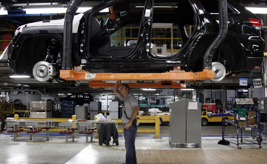 Jeff Caldwell checks a vehicle on the assembly line at the Chrysler Jefferson North Assembly plant in Detroit in May. U.S. auto sales rose last month to their fastest pace since 2007.