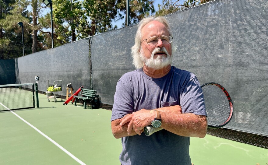 Tennis coach Woody Blocher holds a tennis raquet during an interview in Rancho Peñasquitos on July 11, 2025.
