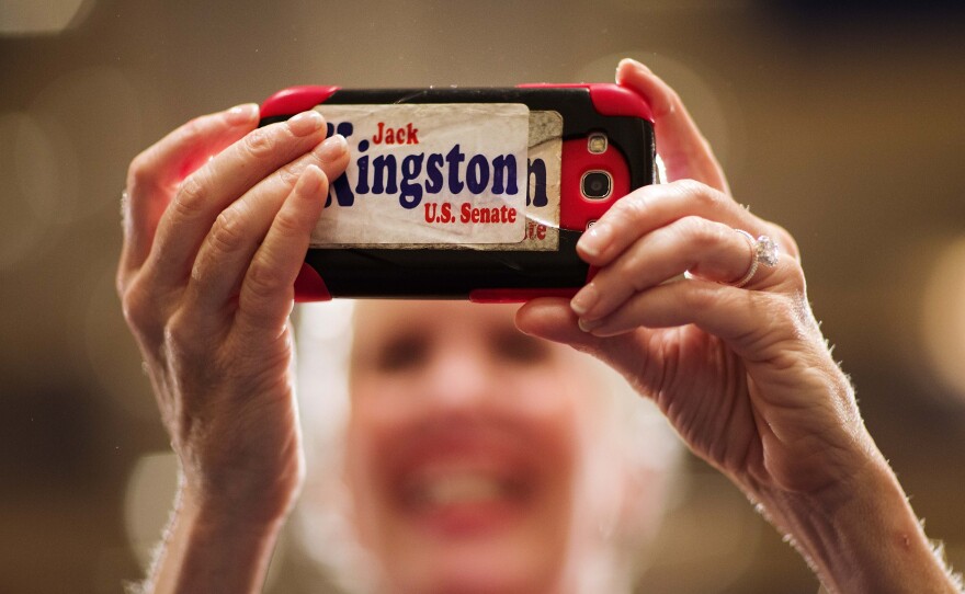 Laney Barroll Stark, of Savannah, Ga., took a picture with her cell phone as Rep. Jack Kingston, who ran for the Republican nomination for U.S. Senate in Georgia, addressed supporters at his primary runoff election night party in July.