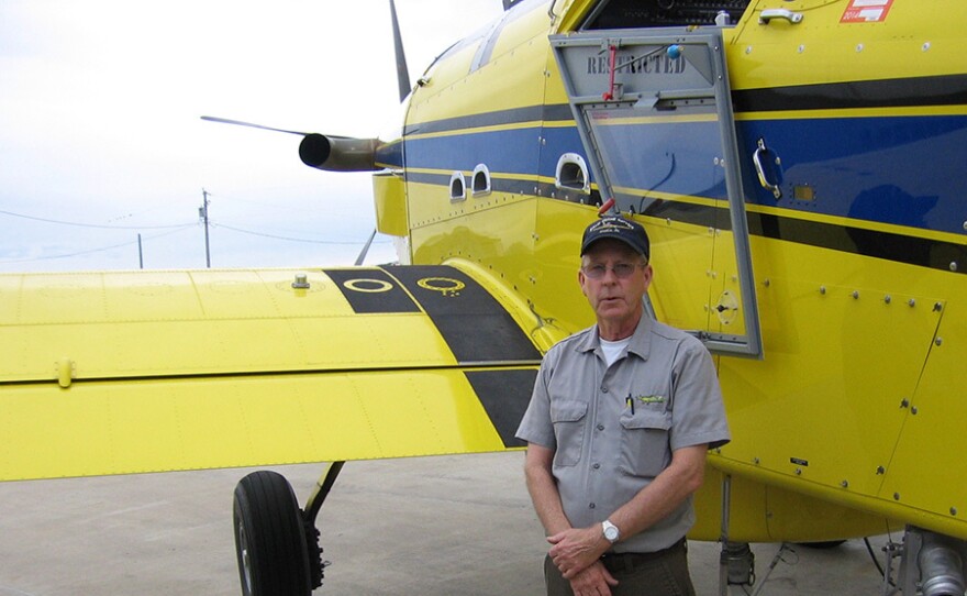 Missouri pilot Mike Lee stands next to a crop duster. "I know some people who have had accidents. I've had friends that got killed in these things," he says.