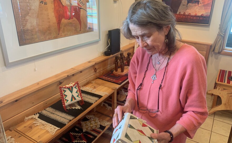 Angelika Harden-Norman holds a parfleche box made by her late husband, Darrell Norman. Harden-Norman made both traditional and modern Blackfeet artwork. Parfleche boxes are painted containers made from animal hide. They were used by Native Americans to carry items as they traveled.