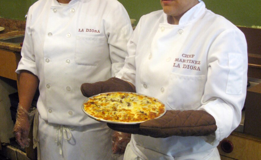 Chef Martinez and her husband, Maurilio Ortega, who also works at La Diosa, get ready to serve a tartizza. Martinez calls her creation something between a tart and a pizza, with a light, flaky crust.