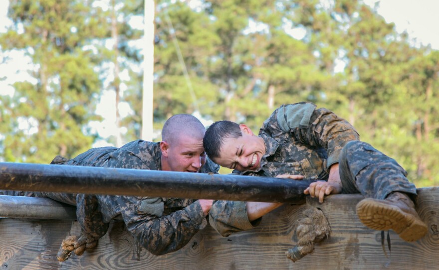 U.S. Army Soldiers conduct the Darby Mile buddy run and an obstacle course during the first gender-integrated Ranger Course at Fort Benning, Ga. Among the 400 students, 19 are women.