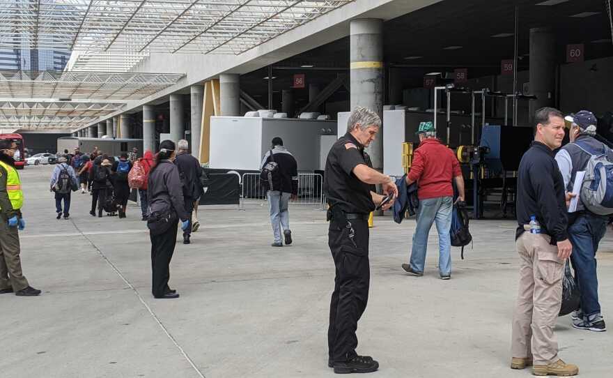 People experiencing homeless being moved into the Convention Center, which is being turned into a temporary shelter during the COVID-19 pandemic, on April 1, 2020.