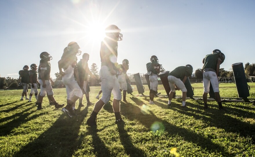 Football practice at Castro Valley High School in California. Proper hitting technique requires players to keep their heads up to prevent neck injuries and concussions.