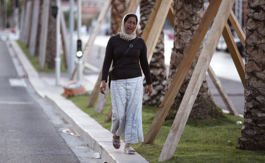 A woman cries, asking for her son, as she walks near the scene of Thursday evening's attack in Nice.