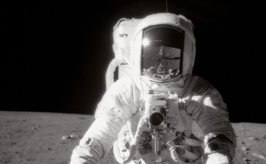 Astronaut Alan Bean was photographed by Charles "Pete" Conrad Jr., who is reflected in Bean's helmet visor, during the Apollo 12 moonwalk in 1969.