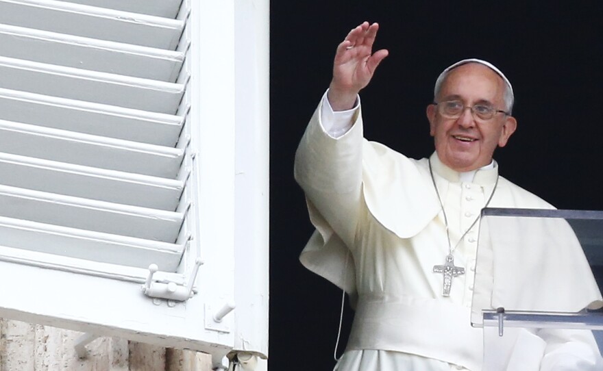 Pope Francis waves in Saint Peter's square at the Vatican. The pope heads to Turkey on Friday, a country with few Catholics, but he plans to reach out to Muslims and to the Orthodox Church.