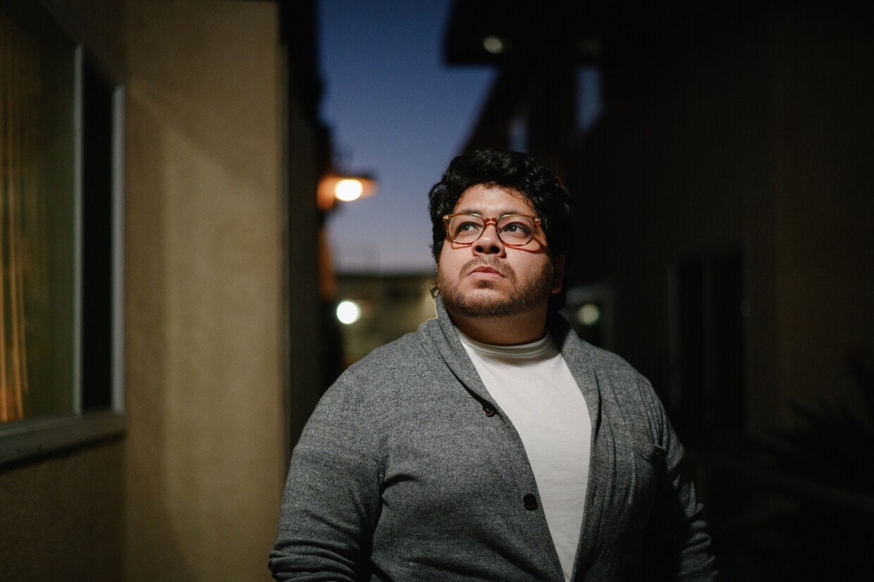 Joshua Lopez stands for a portrait outside his home at the Hawaiian Gardens apartments in Imperial Beach, California on Nov.18, 2024. Lopez is one of dozens of tenants facing eviction and is urging the City Council to pass new local protections for renters.