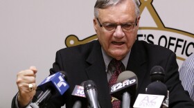 A defiant Maricopa County Sheriff Joe Arpaio answers questions about the Justice Department's lawsuit against him during a news conference in Phoenix last month.
