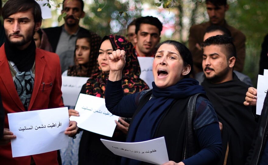 Activists protest in Kabul against Taliban militants who stoned an Afghan woman to death after accusing her of adultery.