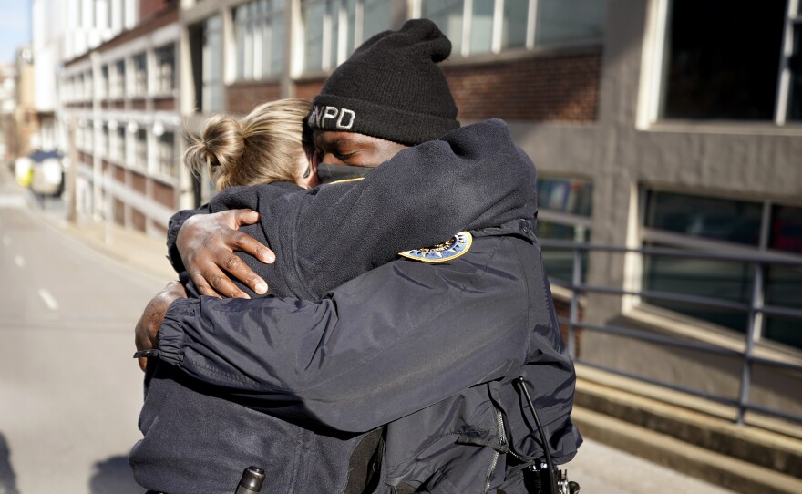 Nashville Police officers Brenna Hosey, left, and James Wells embrace after speaking at a news conference Sunday in Nashville. Hosey and Wells are part of a group of officers credited with evacuating people before an explosion took place in downtown Nashville early Christmas morning.