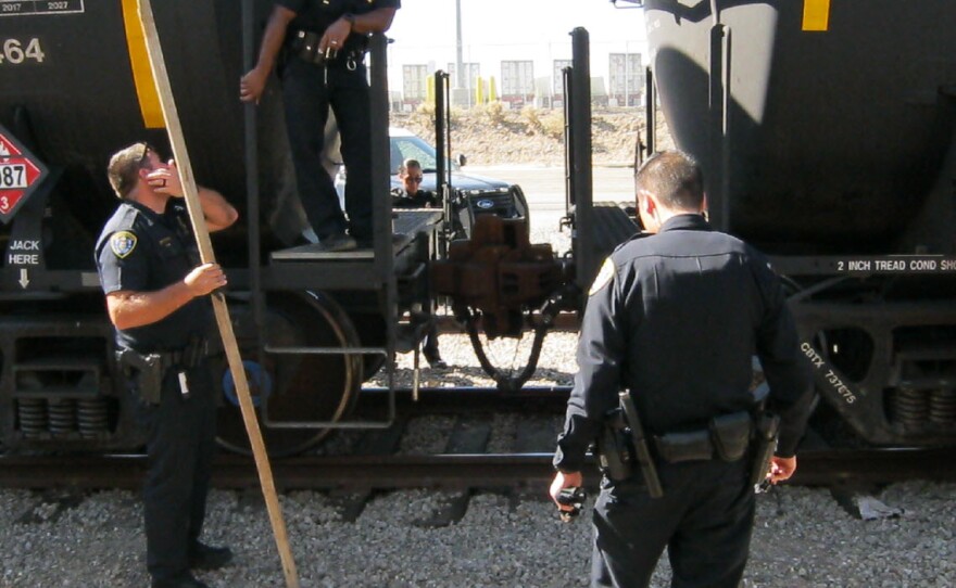 San Diego police officers respond to a man who was throwing railroad spikes at officers on Cesar Chavez Parkway, Oct. 24, 2019.