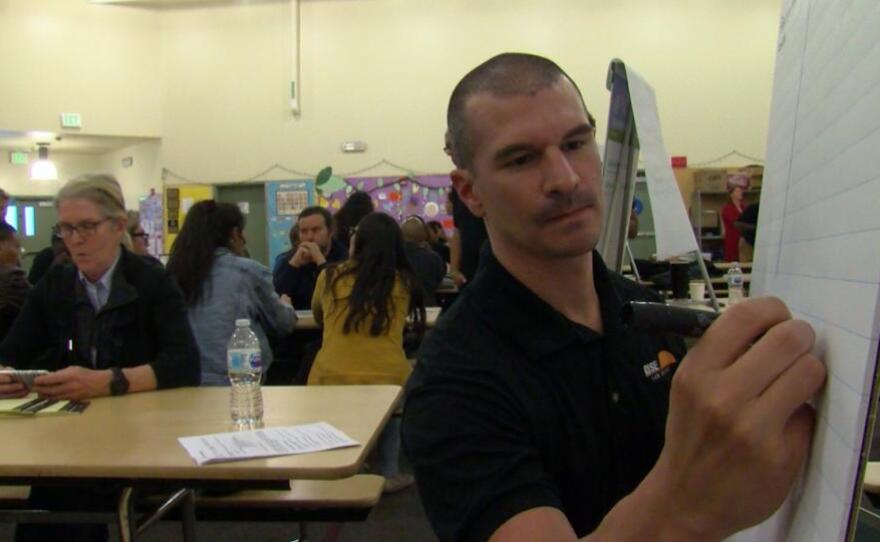 A meeting facilitator with the nonprofit RISE San Diego takes down community input at a town hall meeting on school board elections, April 26, 2018.