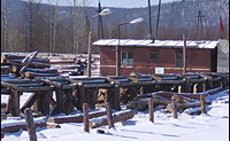 A logging camp in the forest 20 miles south of Tynda bears a red North Korean flag in the distance.