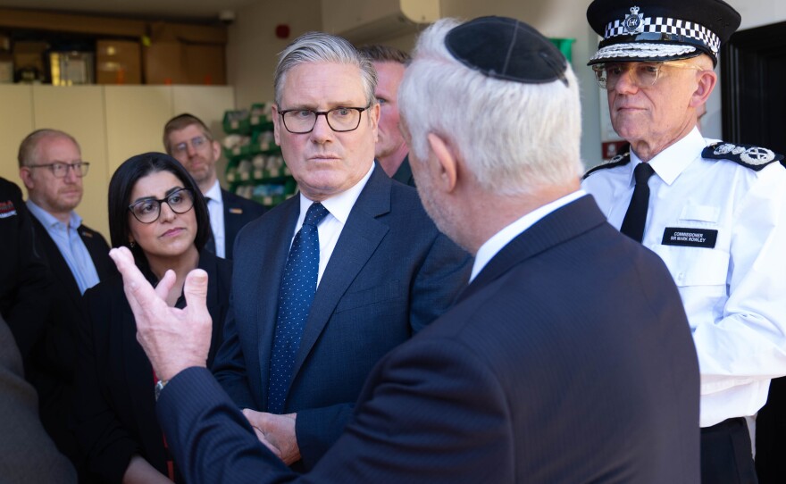 Britain's Prime Minister Keir Starmer (center), Metropolitan Police Commissioner Mark Rowley (right) and Home Secretary Shabana Mahmood (2nd left) speak with members of the Jewish community during a visit to Golders Green, north west London, Thursday, following an attack on Wednesday in which two men were stabbed.