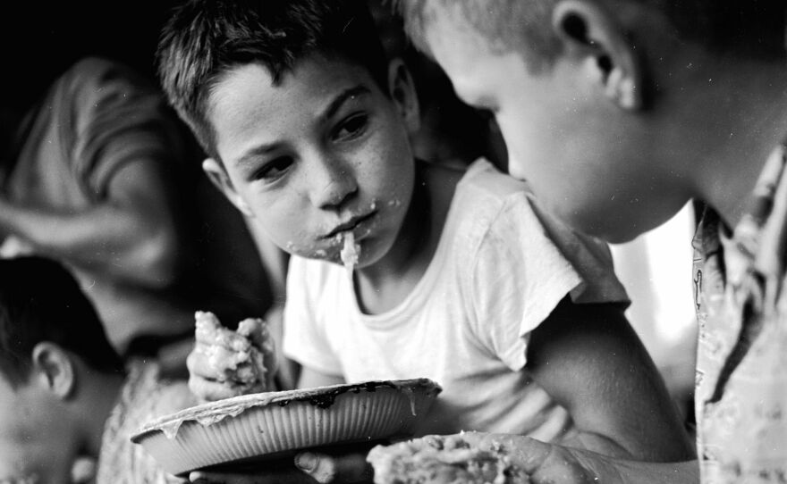 Two young boys pause for breath during an apple pie eating contest during Big Apple Day in Ohio, circa 1947.