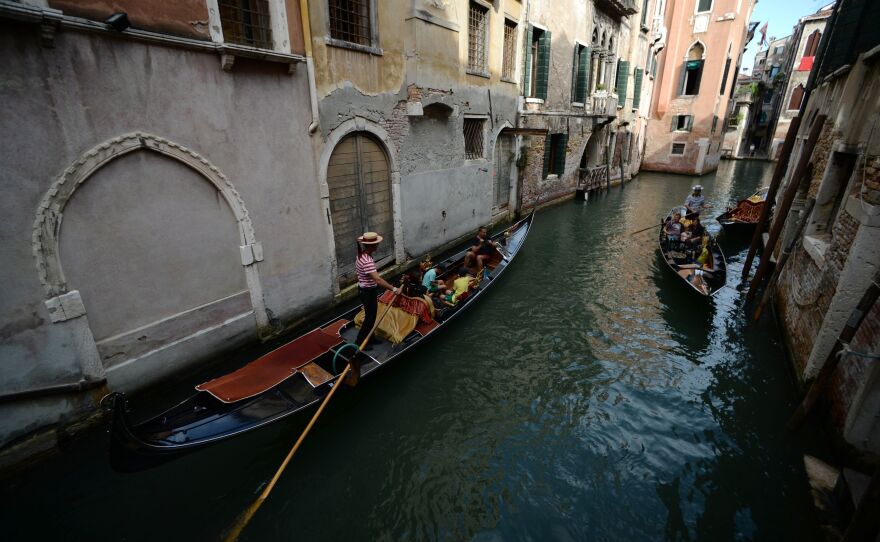 A gondola sails in a Venice canal in September.