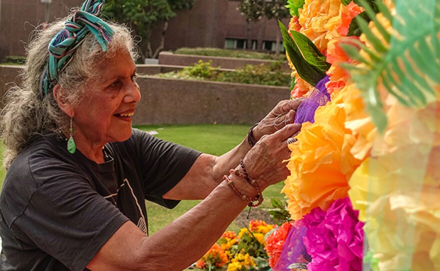 Master altar maker Ofelia Esparza creates her community altar at Grand Park, Los Angeles.