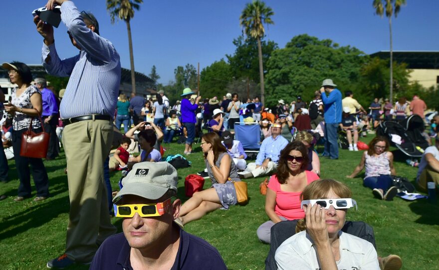 Eclipse enthusiasts wearing protective glasses view a partial eclipse from Beckman Lawn at Caltech in Pasadena, Calif., on Aug. 21, 2017. Another solar eclipse is just weeks away.