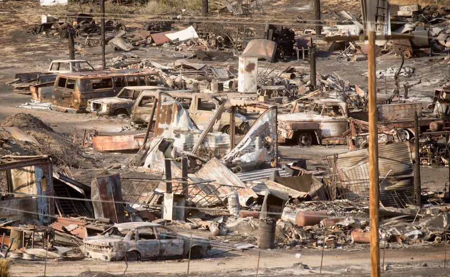 Scorched cars and trailers burned by the Blue Cut fire line a residential street in Phelan, Calif., on Friday.