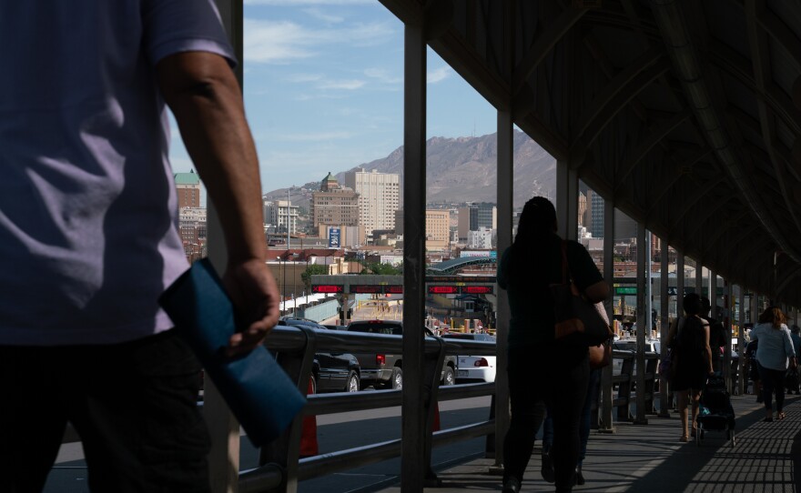 People cross the Paso del Norte International Bridge in the morning on their way to the U.S. Migrants with scheduled court hearings cross the bridge before being taken into custody and transported to court.