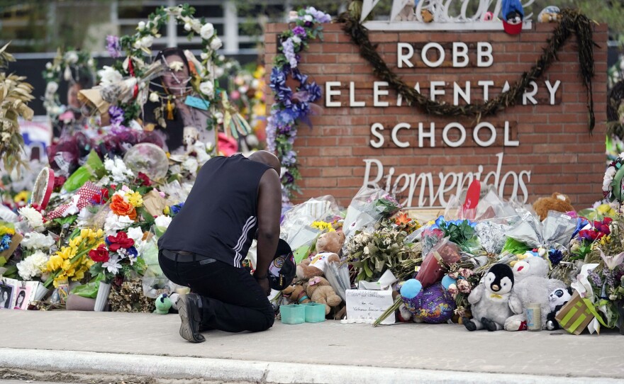 Reggie Daniels pays his respects a memorial at Robb Elementary School on June 9, 2022, in Uvalde, Texas. Nearly 400 law enforcement officials rushed to the mass shooting that left 21 people dead at the school, but it was more than an hour before the gunman was finally confronted and killed, according to a report from investigators released Sunday, July 17, 2022.