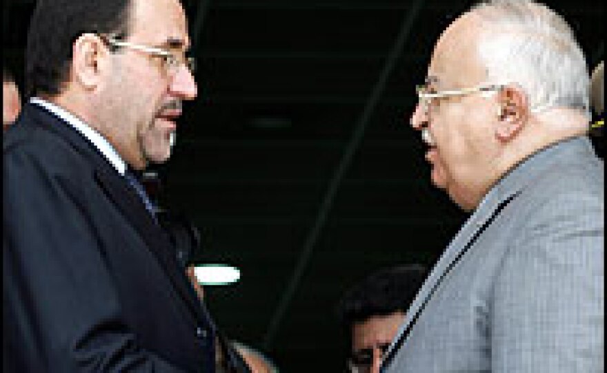 Iraqi Prime Minister Nouri al-Maliki (left) greets his Syrian counterpart, Mohammed Naji Ottri, in Damascus. Al-Maliki rebuffed U.S. criticism of his government.