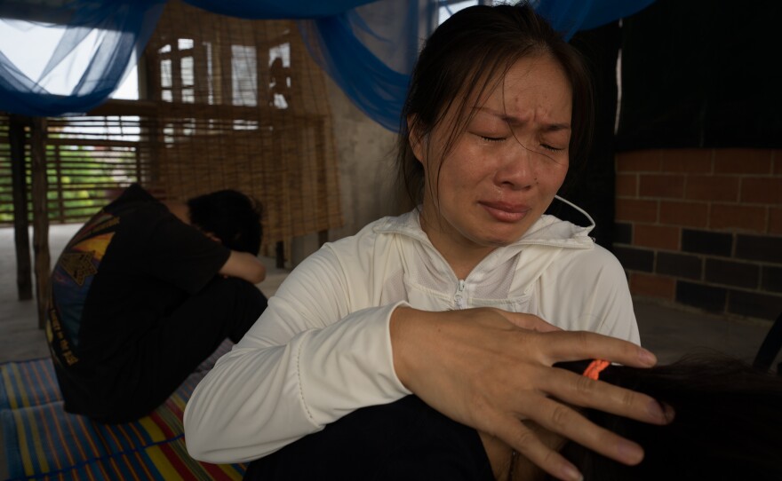 Liu Fengling comforts her daughter and son in Bangkok after spending four months in detention.