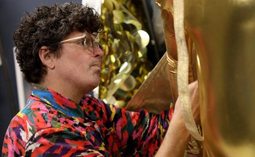 Machine Dazzle alters the Apollo costume during a fitting for Opera Lafayette's production of the previously unfinished Rameau opera <em>Io</em>.